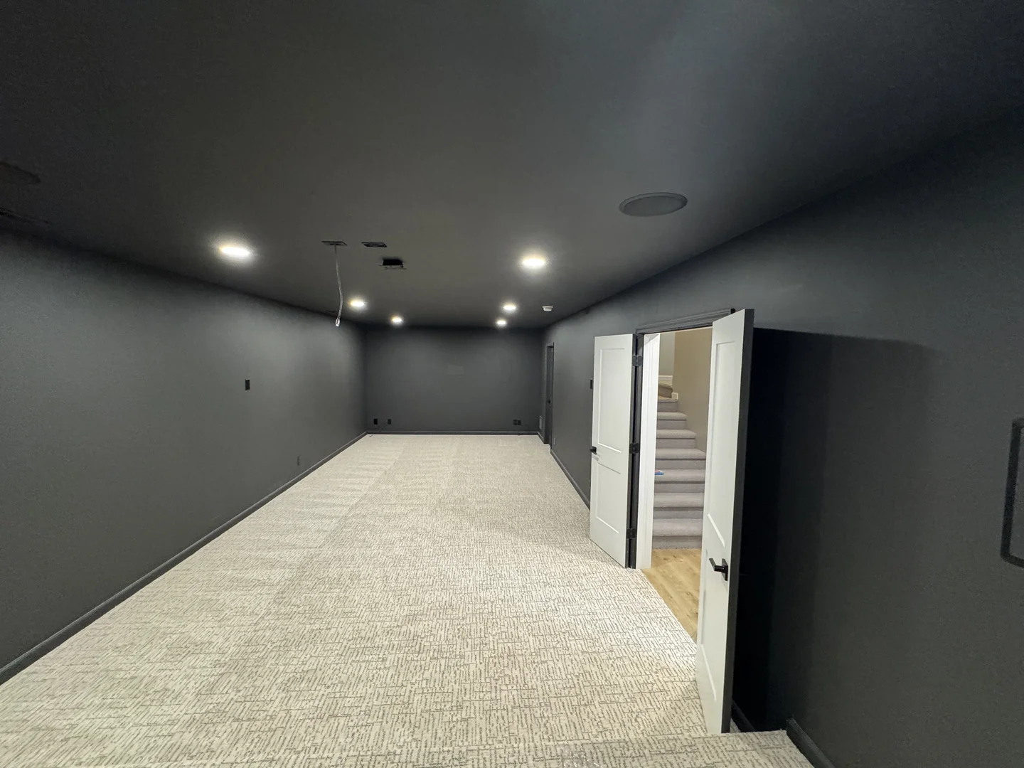 Finished basement with family gathering space and built-in entertainment area in Omaha