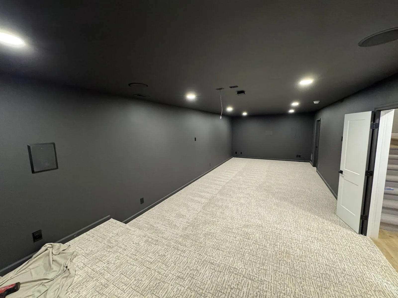 Custom basement remodel with home theater and entertainment setup
