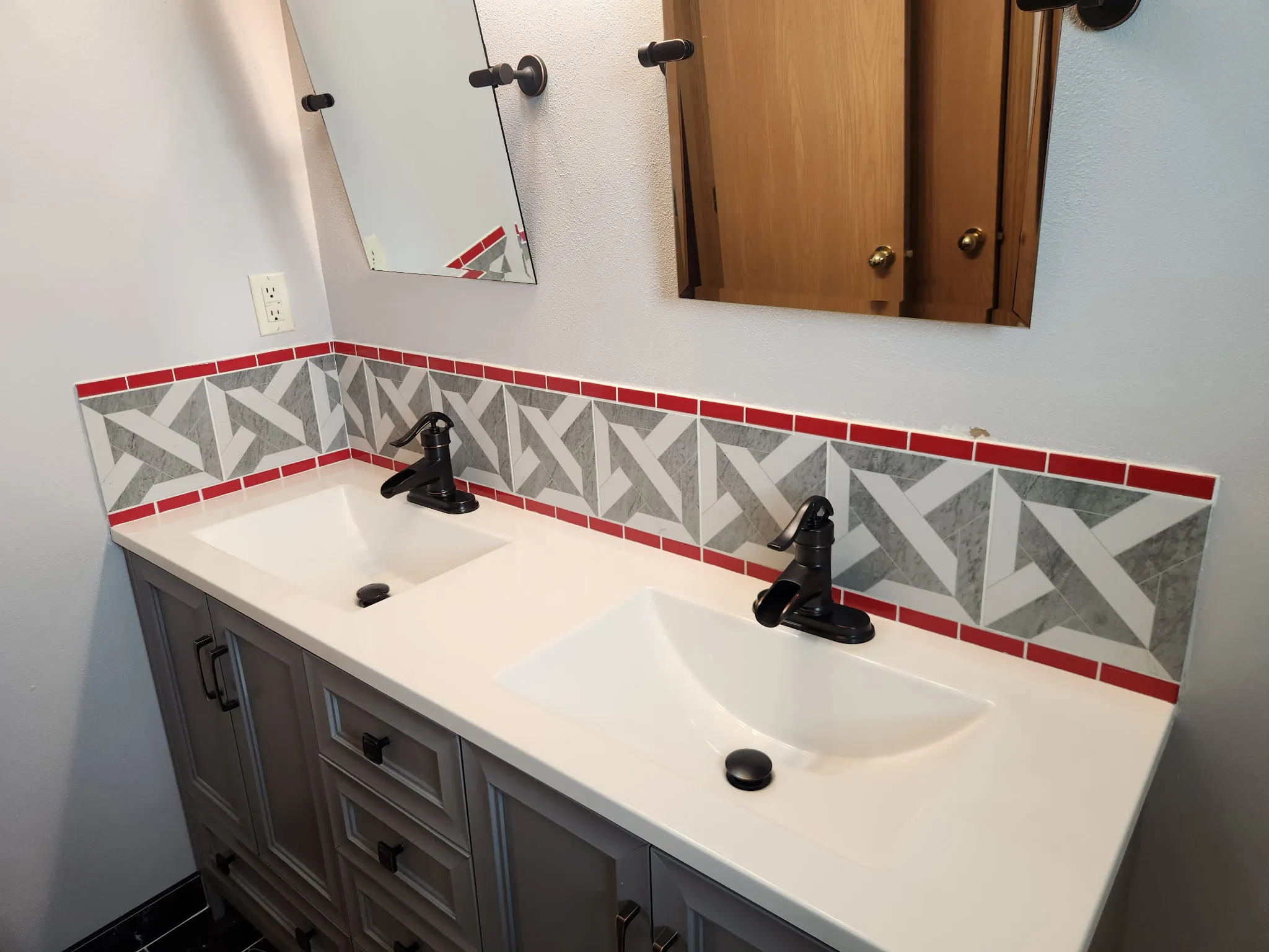Luxury bathroom renovation with double vanity and custom tilework